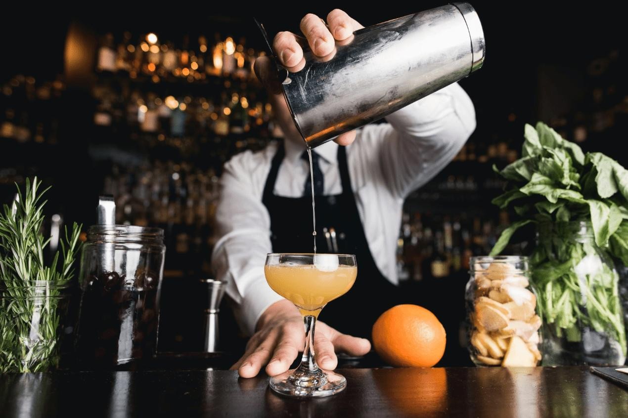 Bartender preparing a signature cocktail Bartender preparing a signature cocktail